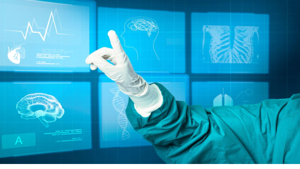 A imagem mostra uma mão usando uma luva médica branca, vestindo um avental cirúrgico verde, apontando para uma interface digital futurista projetada como uma tela virtual azul.
